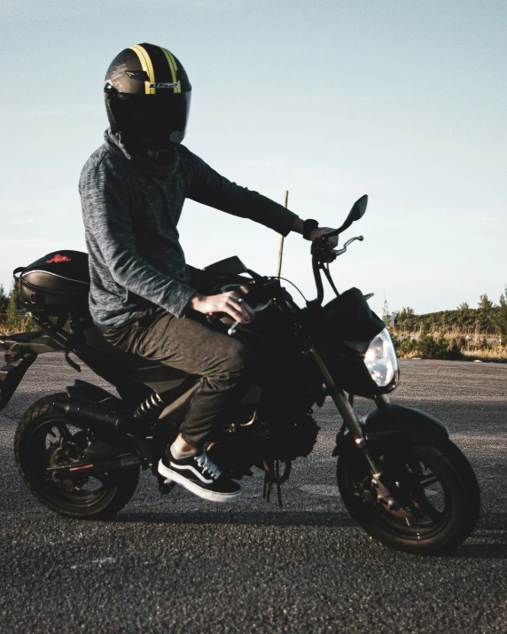 a man sits on top of his motorcycle