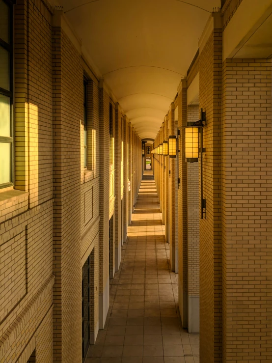 a long hallway lined with yellow lights at the end