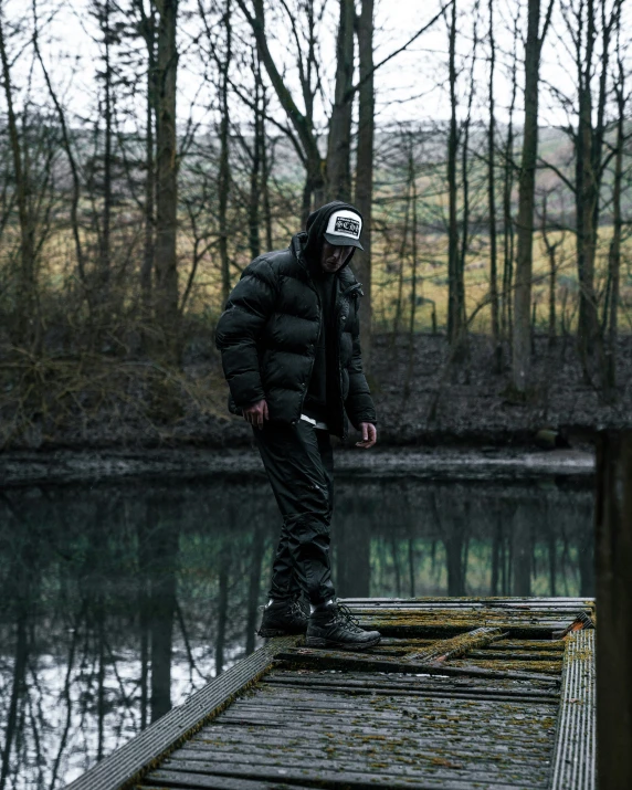 a man is standing on a bridge in the water