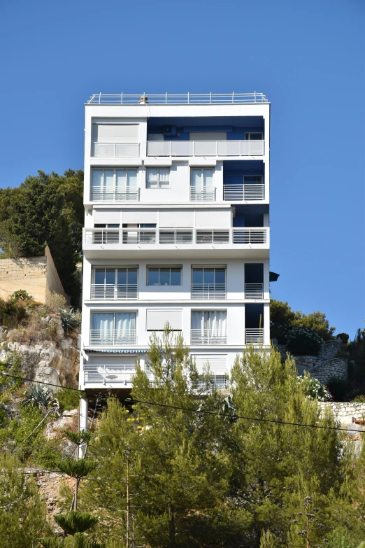 a white building sits on top of trees