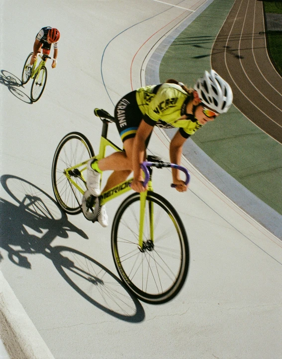 a man riding a bike down a road next to a cyclist