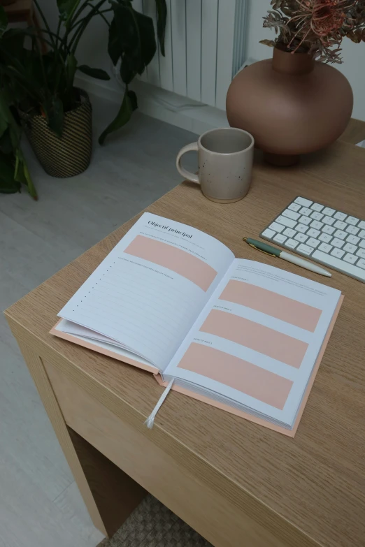 a book open on a wooden desk near a keyboard