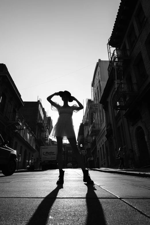 a woman posing in the middle of a city street