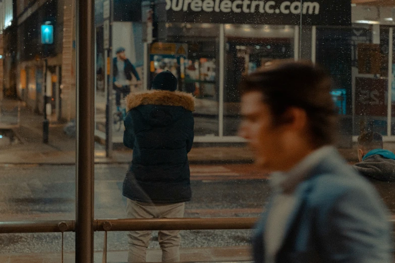 a man walking down the sidewalk near a building