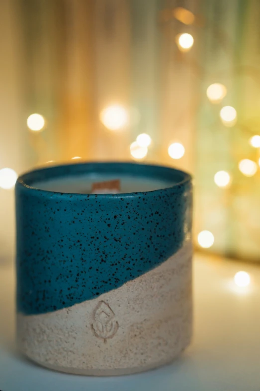 an image of a teal candle on the table