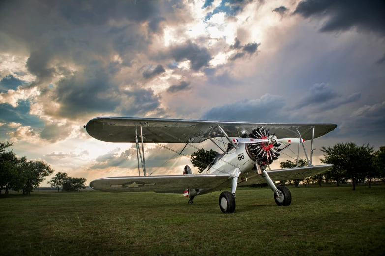 a plane on the ground under a cloudy sky