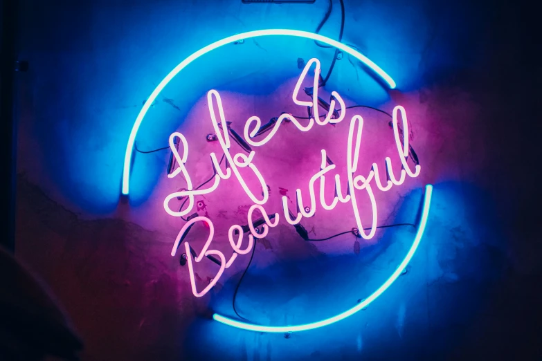 the neon light sign says life's beautiful on the dark background