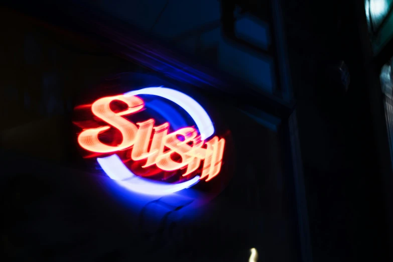 a neon sign saying the name stuky above it