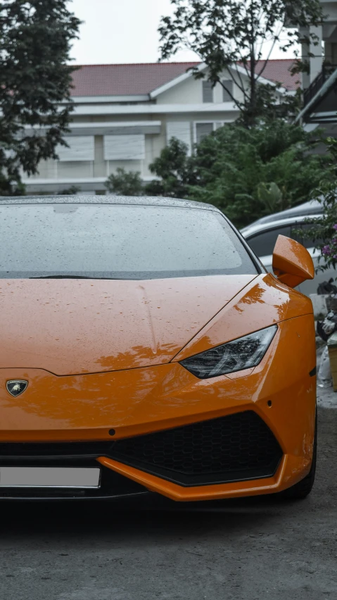 an orange sports car parked in a lot