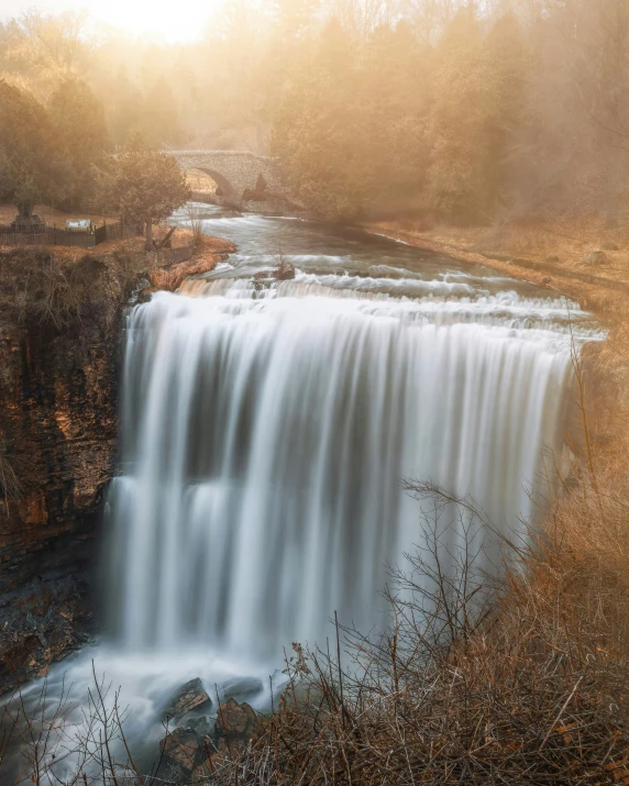 a long waterfall with some water cascading over it