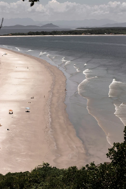 people on a sandy beach next to a body of water