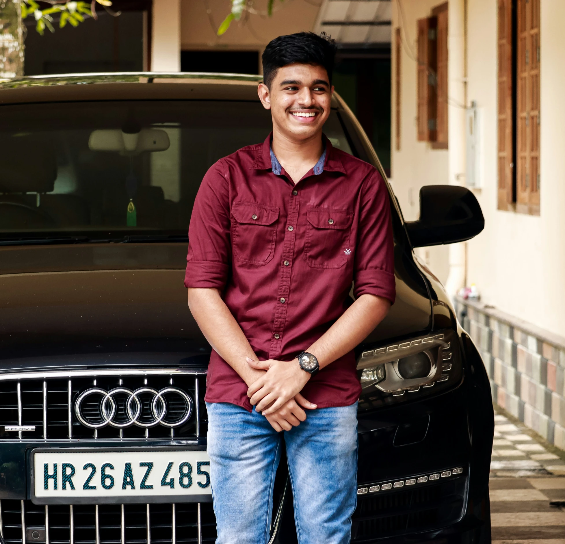 a man standing in front of a black audi