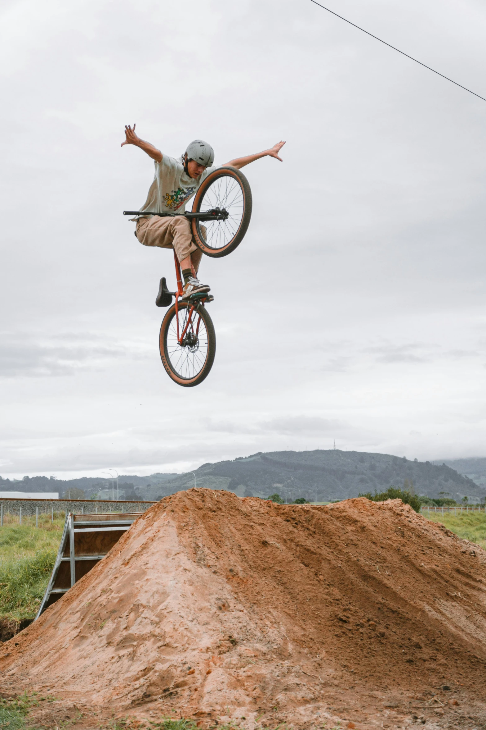 a man on a bike doing a trick in the air