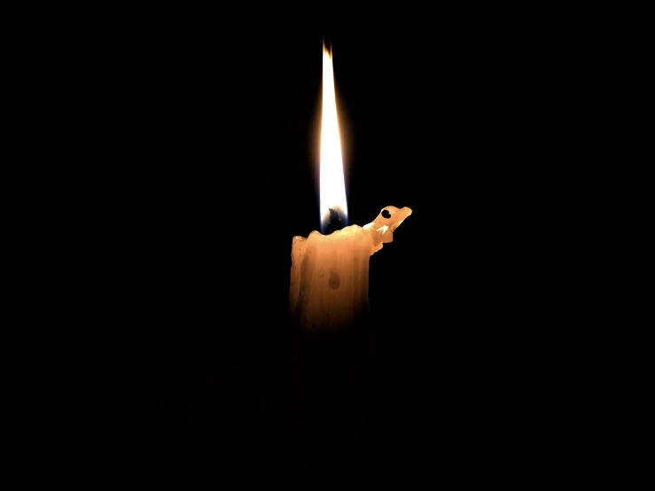 a candle lit up in the dark with a candle lit up inside