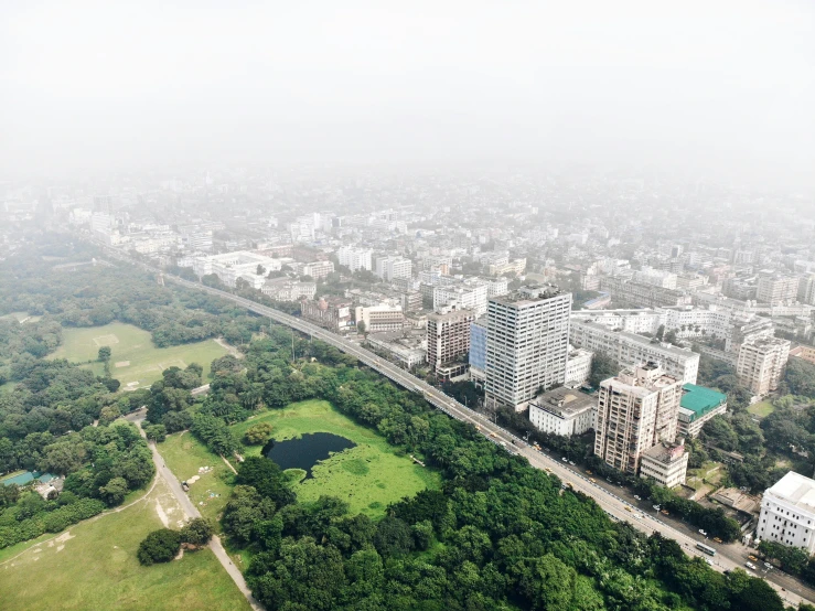 a very large city with trees and grass on both sides