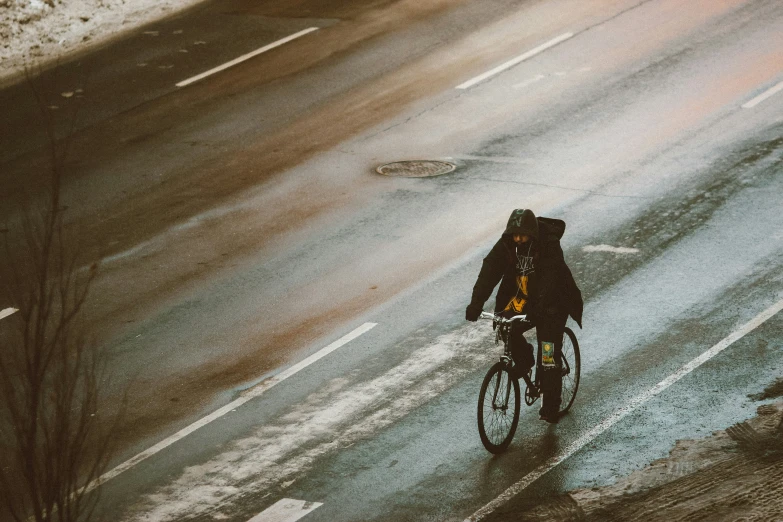 a person riding a bike down the road