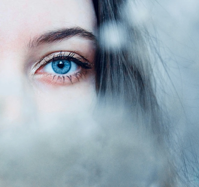 a girl with dark blue eyes and false eyelashes