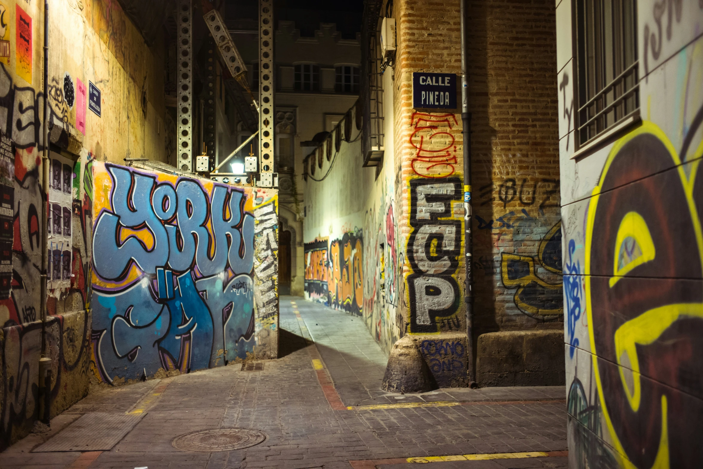 an alley filled with graffiti and walls