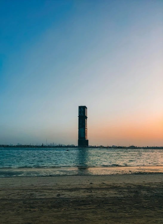 a tall tower is standing in the water