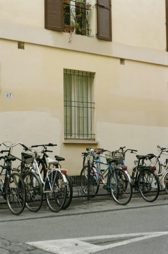 bicycles lined up against the side of a building