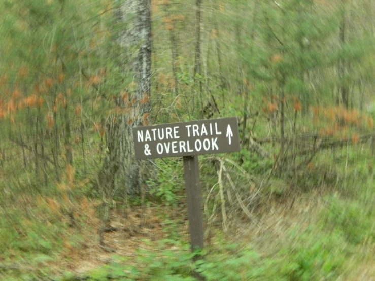 a sign points the way to a nature trail and overlook