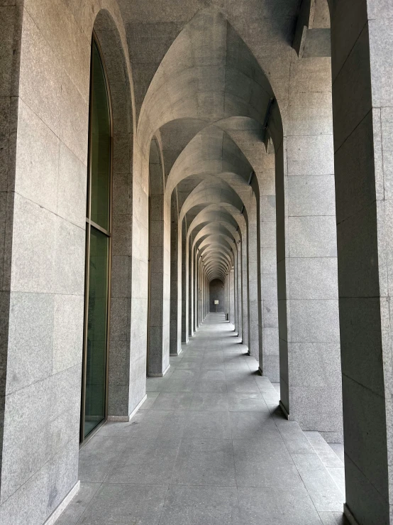 the corridor is lined with identical arched stone walls