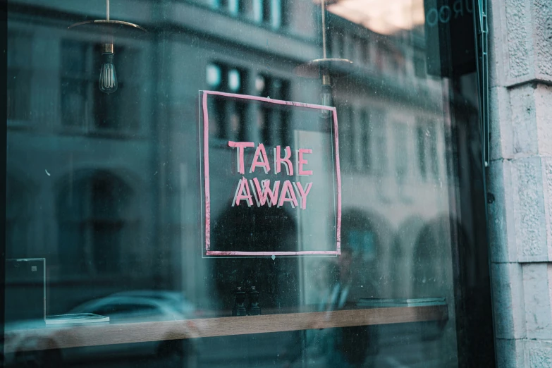 an upside down take away sign on the side of a building