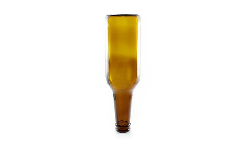 a yellow glass vase is sitting on the floor