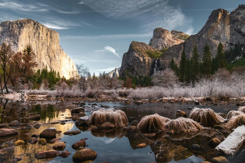 the mountains are covered with trees, rocks and ice