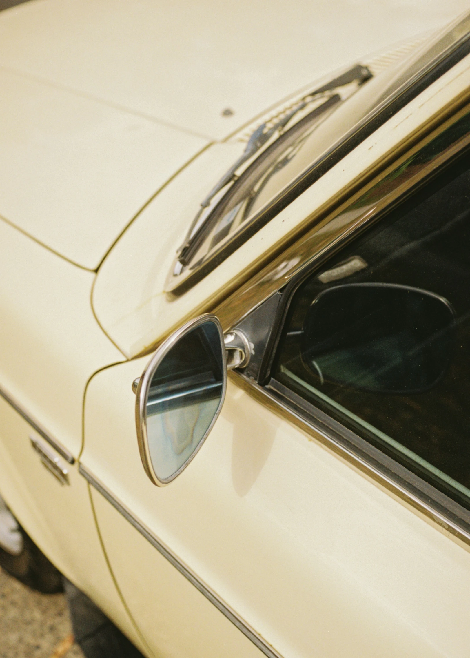 the door handle of a vintage car showing sunglasses