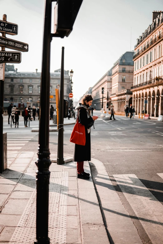 a woman standing in front of a road filled with lots of people