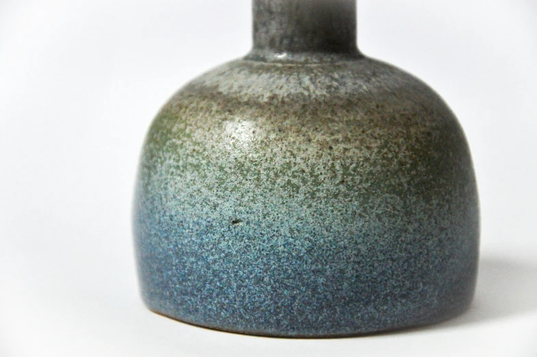 the blue and gray vase is shaped to resemble a bottle