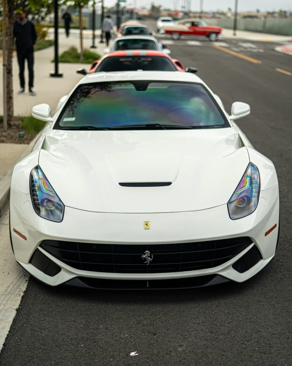 some white sports cars parked next to each other