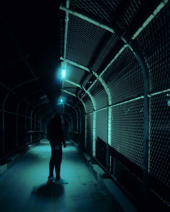 a man riding a skateboard into the dark tunnel
