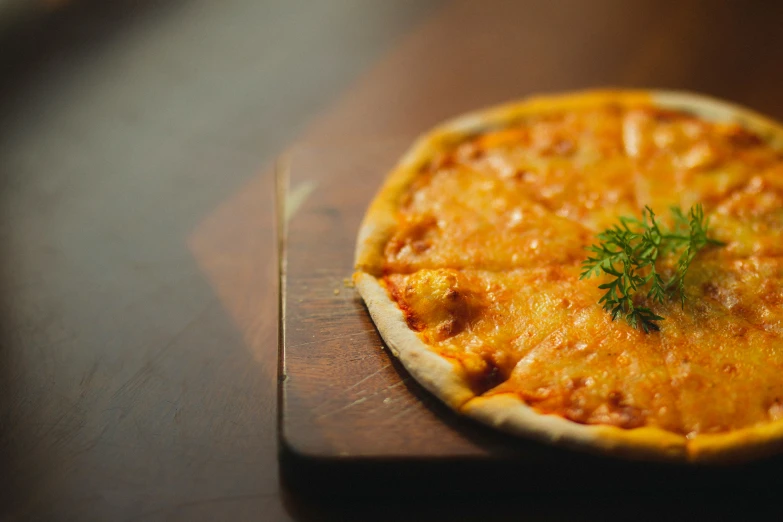 a small pizza is on a wooden table