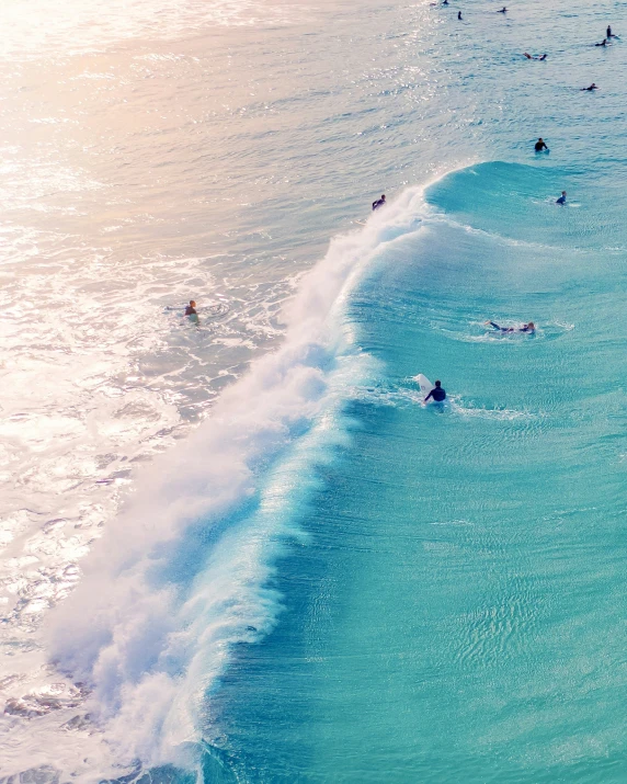 a beach filled with people swimming in the ocean