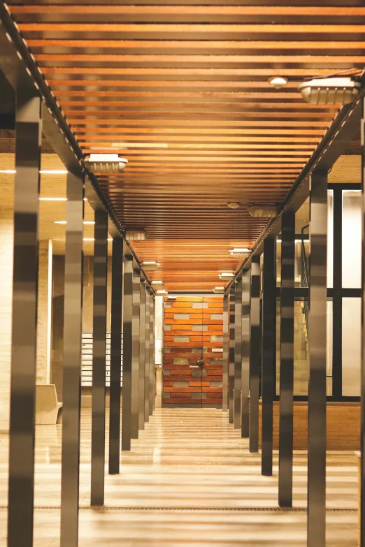 an empty room with tall metal and glass poles