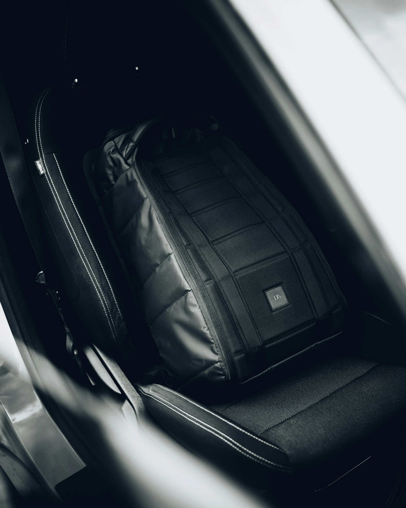 suitcase sitting in an empty trunk with its door open