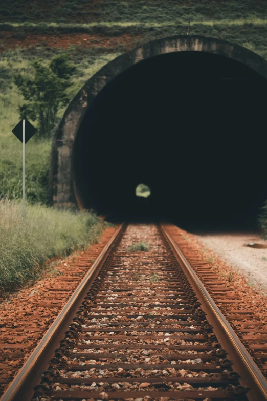 a train track going through a tunnel