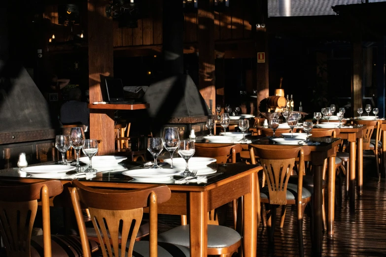 dining tables and chairs are set up in a dark restaurant