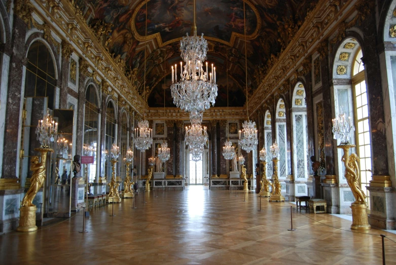 a lavish hall with chandeliers and glass windows