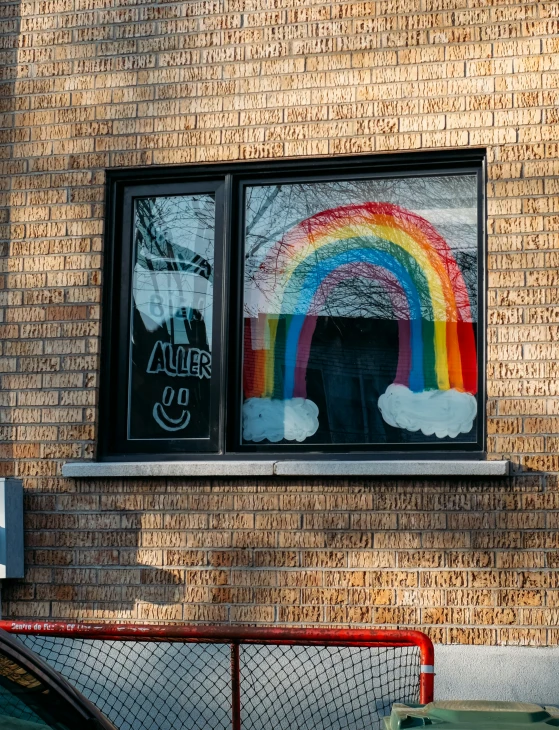 a window with a rainbow painted on it