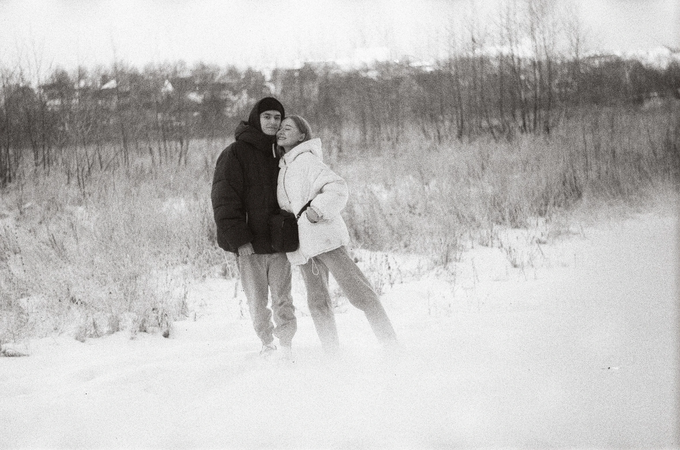 two people are hugging in the snow