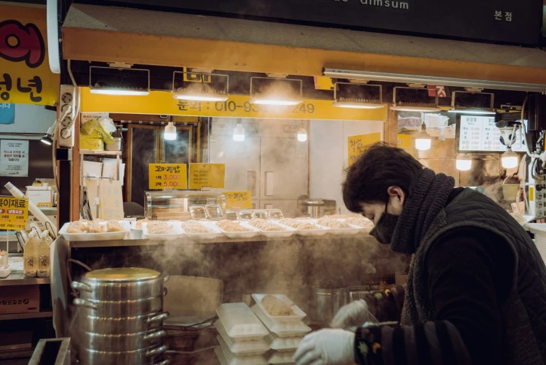 man wearing white gloves and working in a kitchen