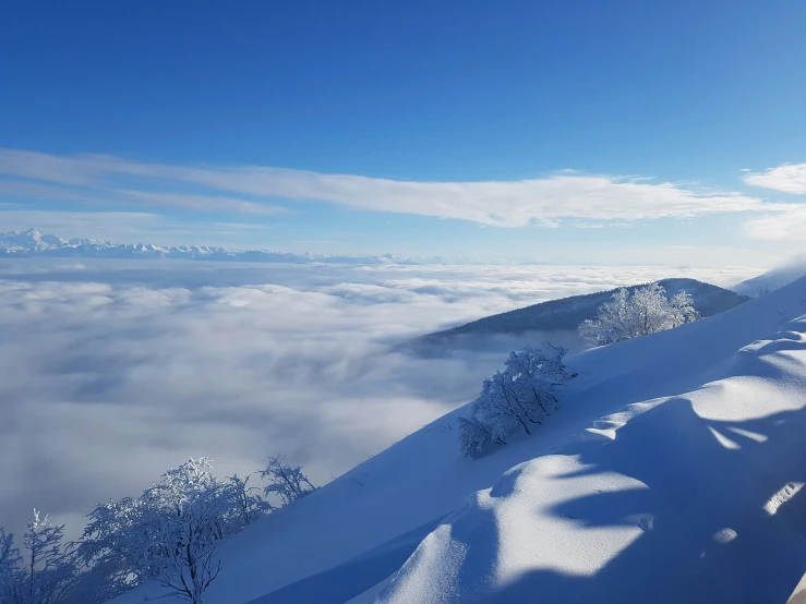 a person standing on a mountain with a skiing gear