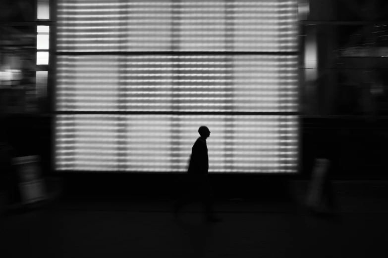 silhouette of a man standing in front of an airport screen