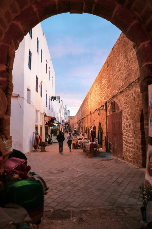 a archway and walkway are leading down to a street