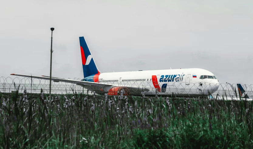 airplane with landing gear down in grassy field