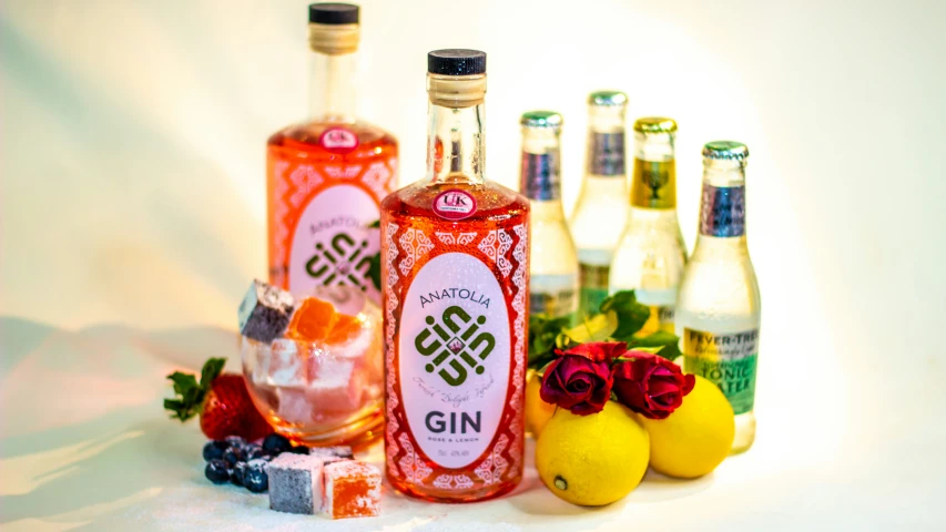 a white table with bottles, oranges and lemonade