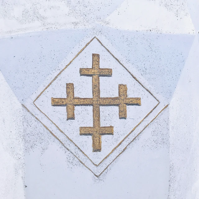 four crosses in a square overlaid on a wall